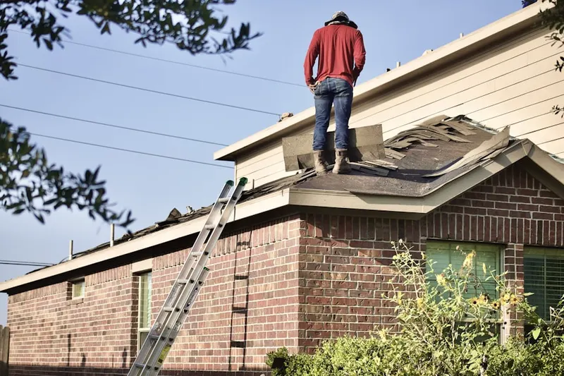 Professional roofer working on a residential roof in Moon